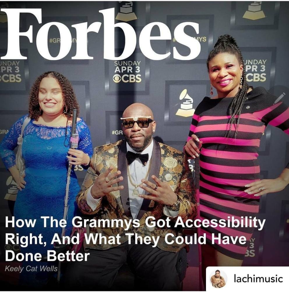 Image Description: In front of a Grammys red carpet backdrop, Namel Norris, a black man in a wheelchair wearing a stylish suit, poses between Lachi, a black woman with cornrows and a red dress, holding a matching glam cane, and Precious Perez, a latina with curly hair wearing a blue gown and white cane fashioned with lights. Above test reads Forbes, below text reads 